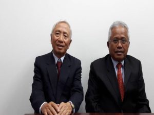 Two senior members of the firm seated